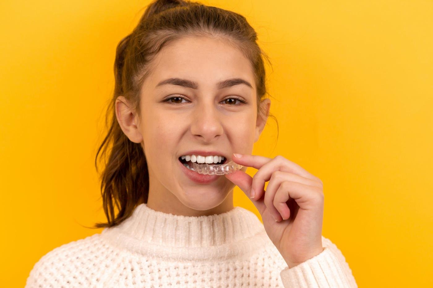 Woman holding a clear aligner